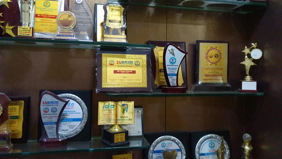 A shelf filled with awards and trophies, showcasing remarkable achievements and accomplishments As a Dentist