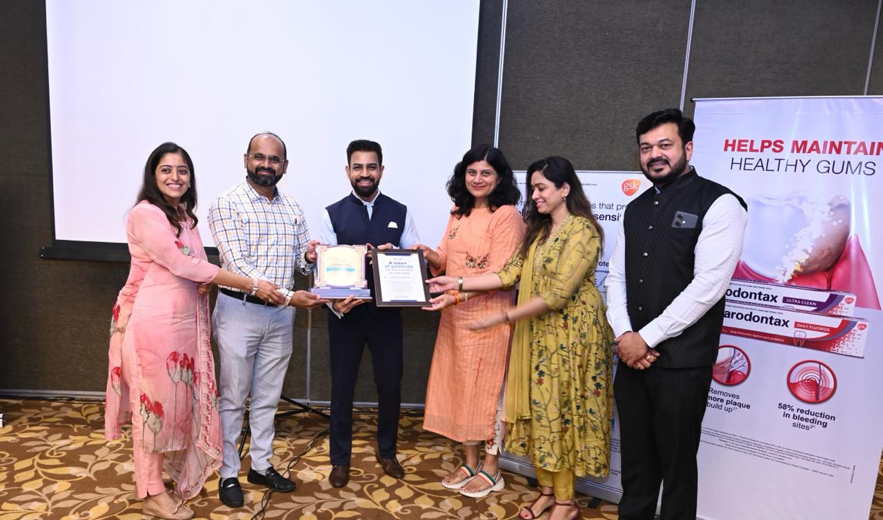 Dr. Gagan & Dr. Shardha Jaiswal getting award certificates for success and commitment in Dental field.