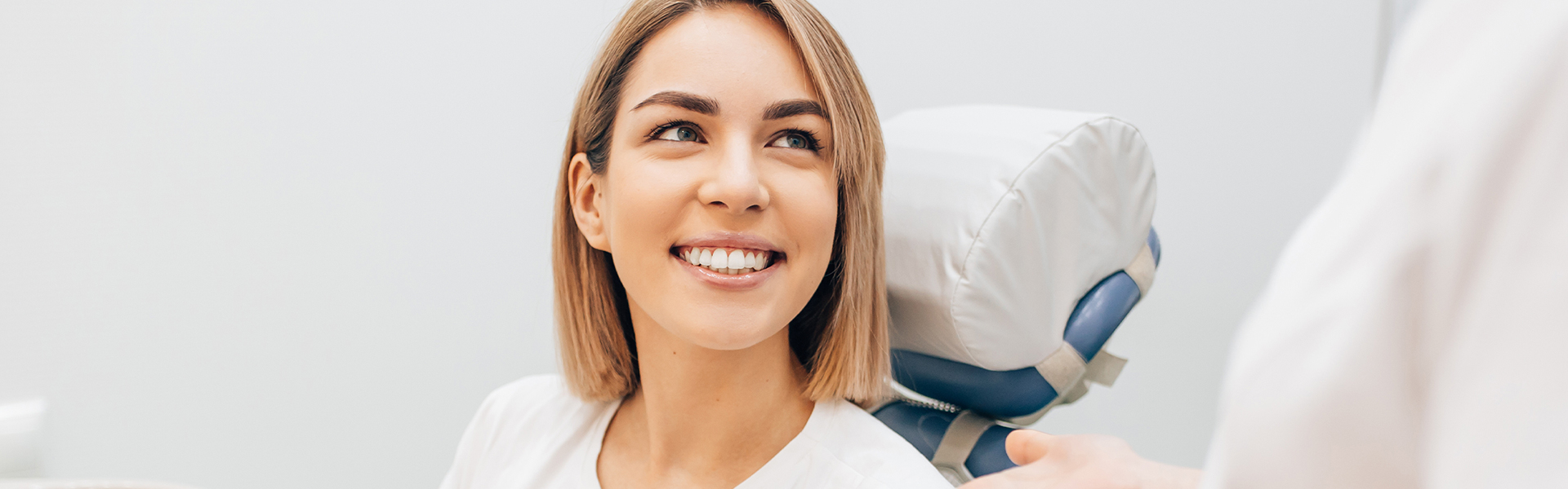 A diverse group of Dentist posing in front of a white wall, in Care dental Clinic.