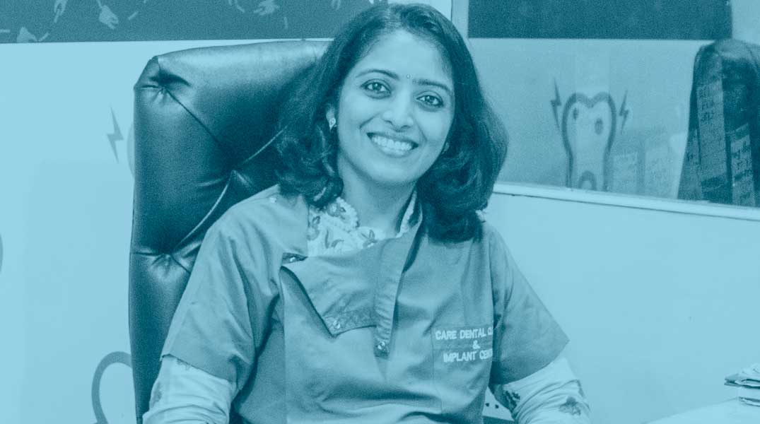 In an office setting, a woman named Dr. Shradha Jaiswal, a dentist and oral pathologist, sits at her desk in Vijay Nagar, Indore.
            