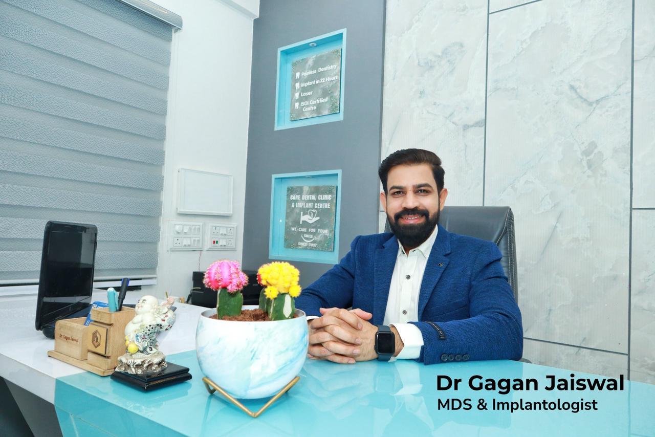 Meet Dr. Gagan Jaiswal MDS and Implantologist, is seated at a desk in our Dental clinic Indore.