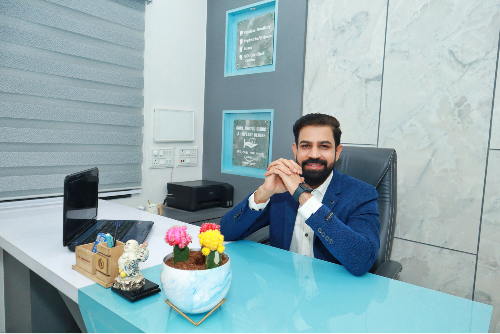 Dr. Gagan Jaiswal, is seated at a desk in our Dental clinic Indore, Vijay Nagar.