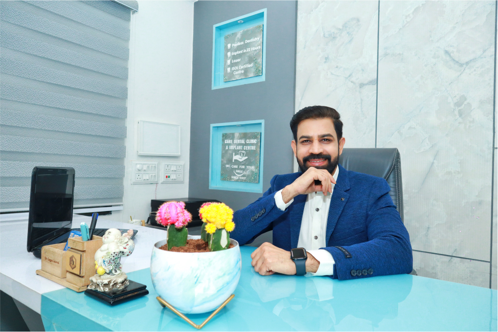 Dr. Gagan Jaiswal, is seated at a desk in our Dental clinic Indore, Vijay Nagar.