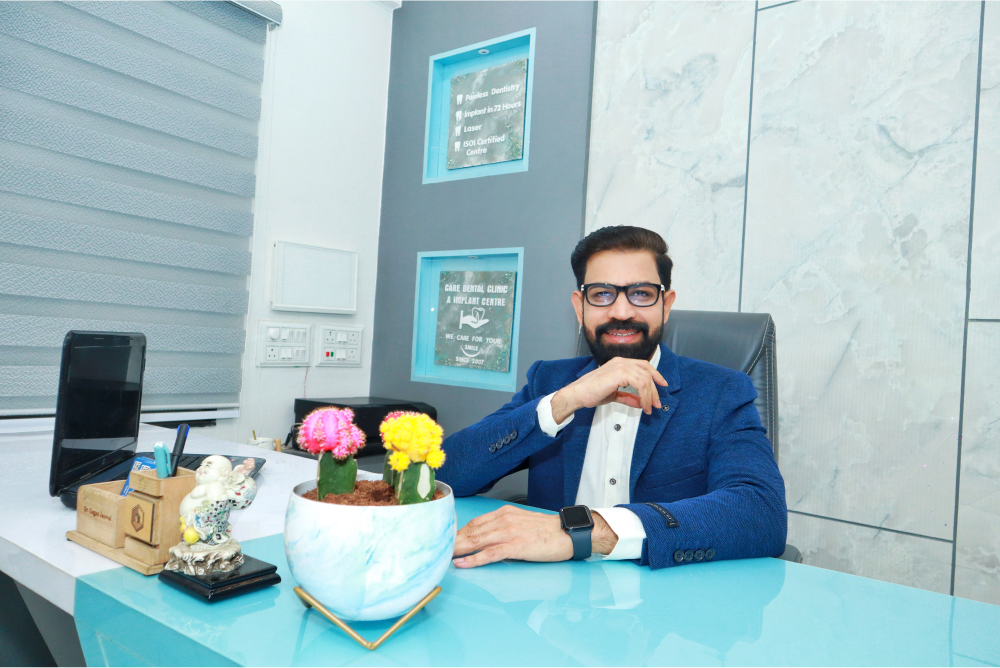 Dr. Gagan Jaiswal, is seated at a desk in our Dental clinic Indore, Vijay Nagar.