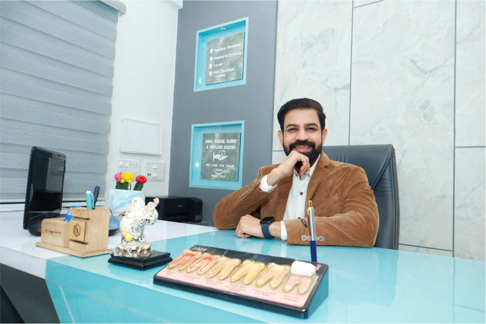 Dr. Gagan Jaiswal, is seated at a desk in our Dental clinic Indore, Vijay Nagar.